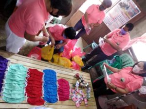 Making masks and food packs in Mindanao.